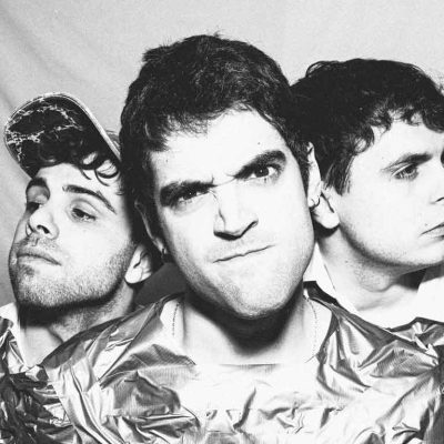 Hanz Ruiz interpretando Cosquilleo con estética indie rock y guitarras enérgicas