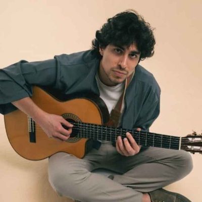 Andrés Iwasaki cantando en directo con guitarra en concierto íntimo
